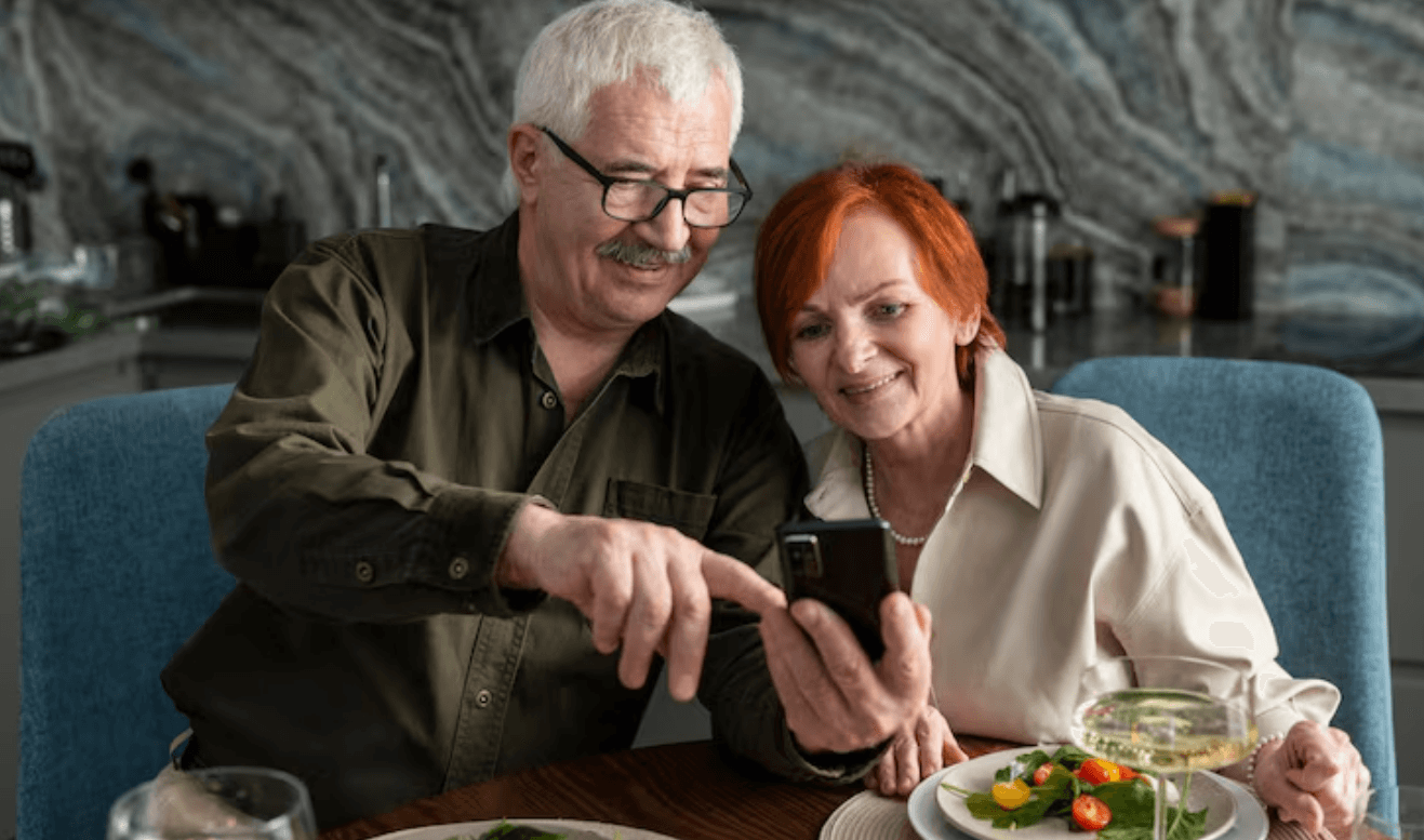 Two older adults looking at a smartphone together